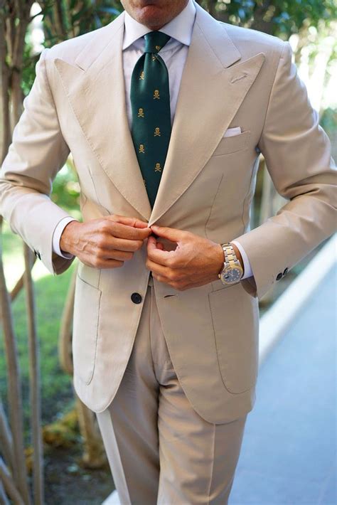 tan suit with green tie.